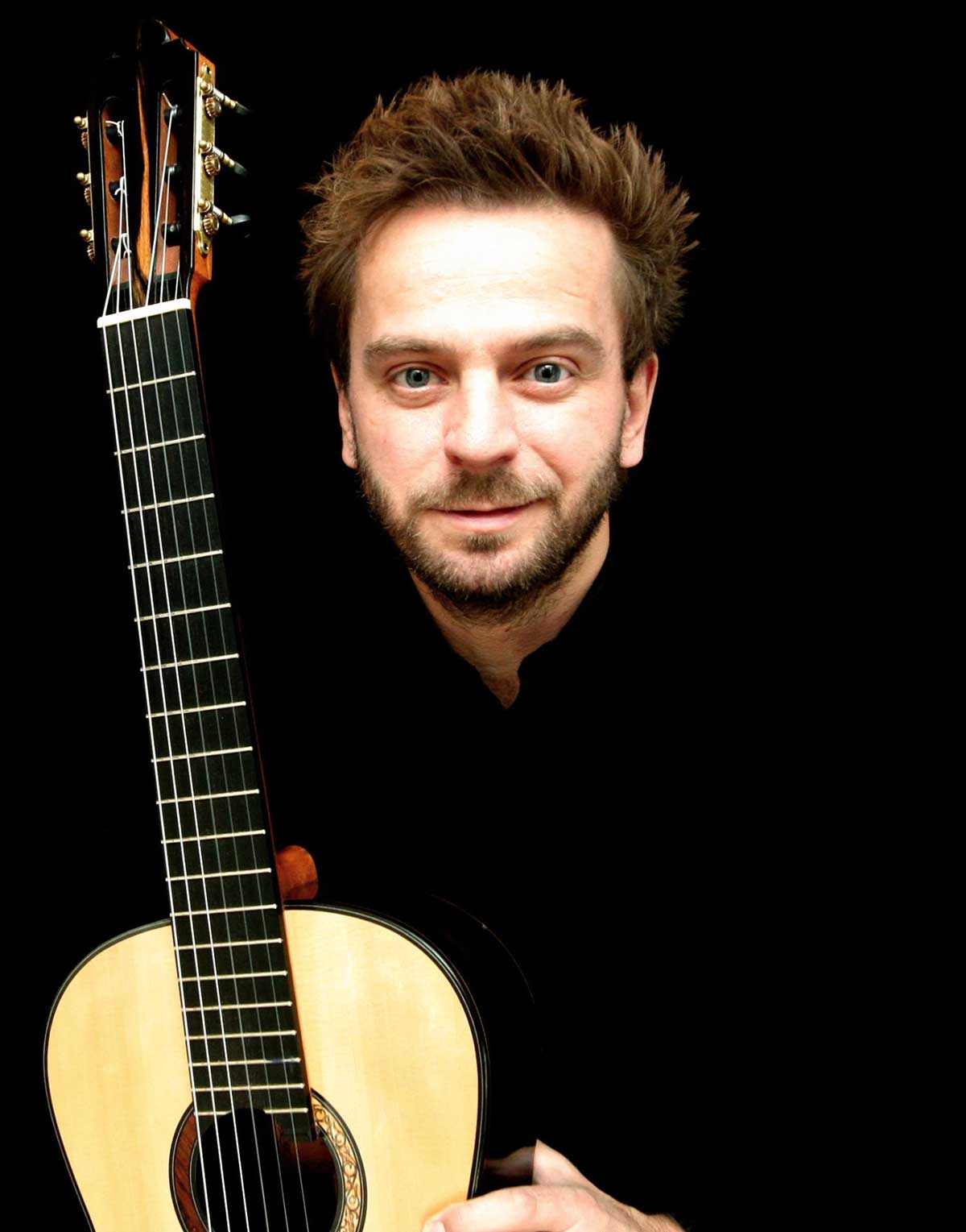 Marcin Dylla with a guitar